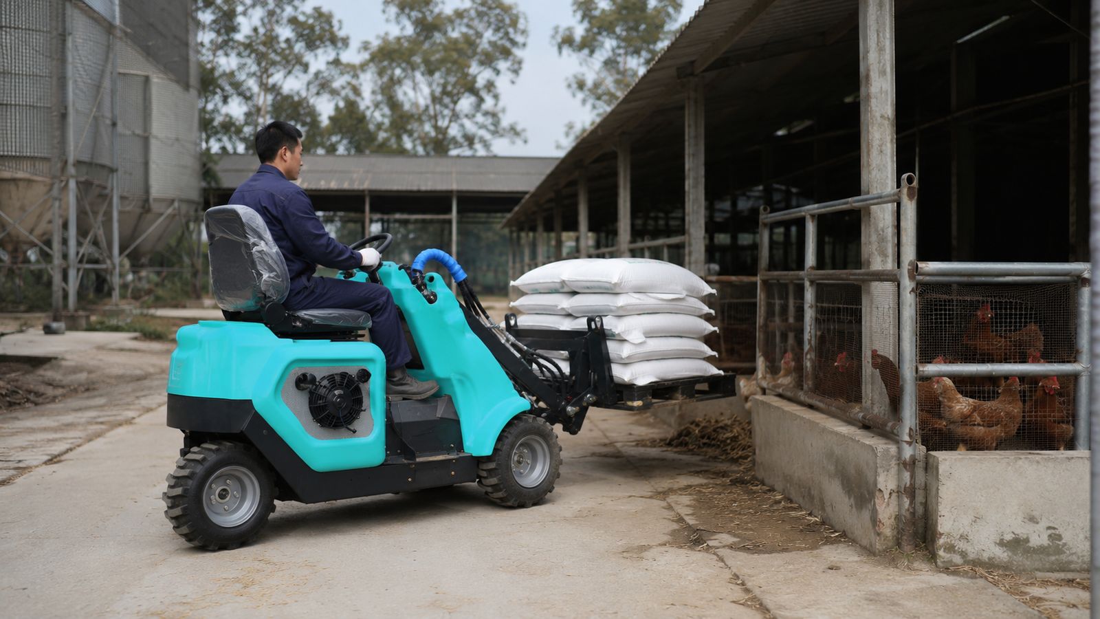 NusLoader NL-15 Compact Loader used at a poultry farm